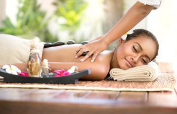 Beautiful relaxed woman getting a hot stone massage.