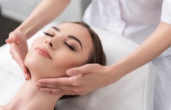 A beautiful relaxed woman during facial massage.